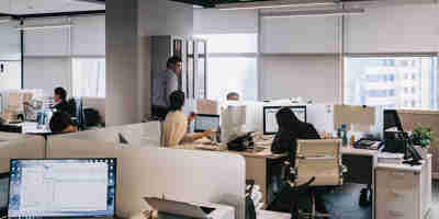 An office of workers working at their desks. Upcoming changes to UK business immigration law