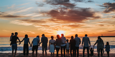 A huge family congregating on a beach for sunset. ¬Billions of pounds worth of assets remain unclaimed as it’s taboo to talk about death: let’s start the conversation