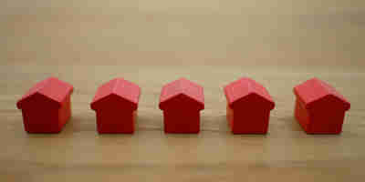 A row of red wooden model houses. EG’s top 10 property law cases of 2023