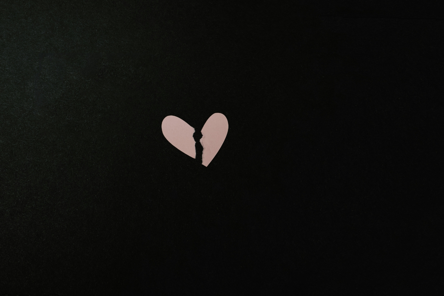 A pink paper heart torn in two to symbolise separation. Key takeaways from the surprising divorce figures for HNWIs and their advisers—eprivateclient