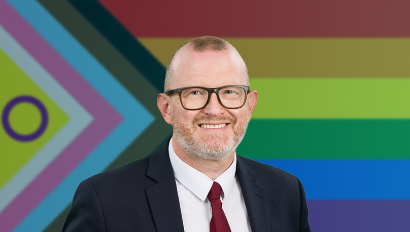 Managing Partner James Carroll of Russell-Cooke LLP overlay a progressive pride flag