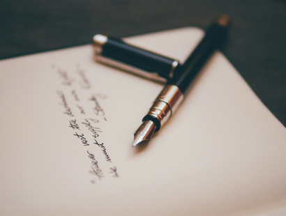 A fountain pen on a handwritten letter of wishes. Five things not to put in a will—Money Week