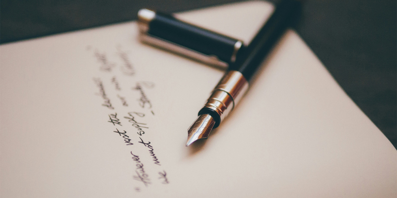 A fountain pen on a handwritten letter of wishes. Five things not to put in a will—Money Week