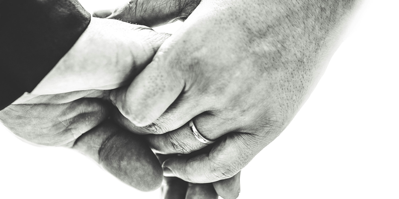 A married couple holding hands. Navigating capacity challenges