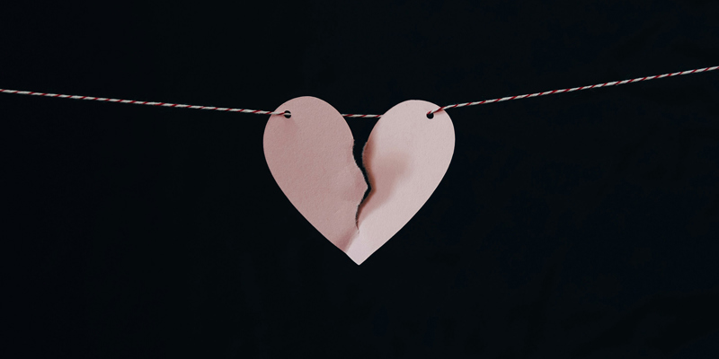 A paper heart on a string, ripped in half to symbolise a broken heart. Debunking common myths about divorce and inheritance