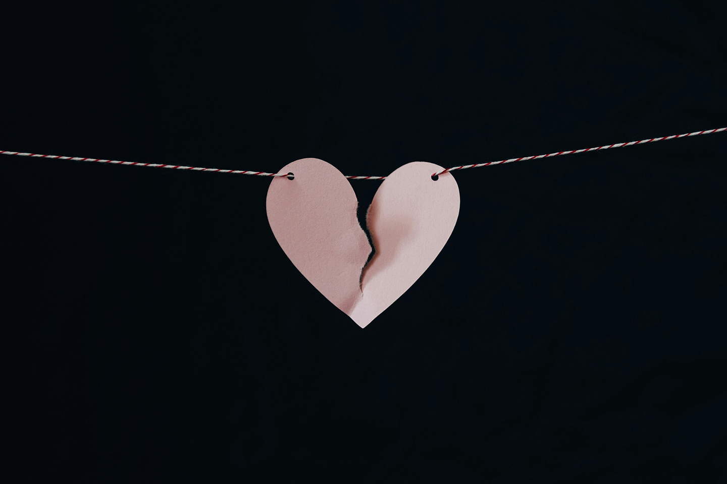 A paper heart on a string, ripped in half to symbolise a broken heart. Debunking common myths about divorce and inheritance