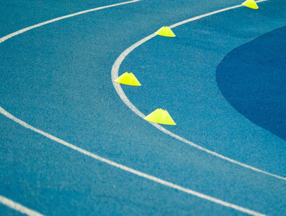 The image shows a blue and white running track. 