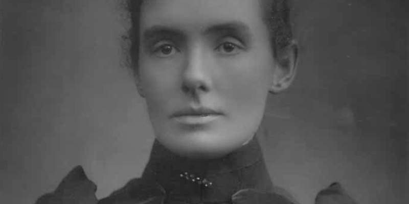 A black and white portrait of Maye Russell Cooke, the wife of the firm's founder and an unwavering campaigner for women's rights