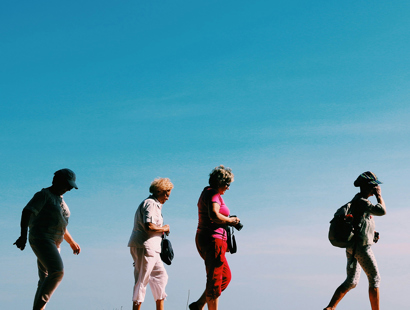 Four middle aged women on a walk with blue skies in the background. The Hughes Report–‘options for redress for those harmed by valproate and pelvic mesh’