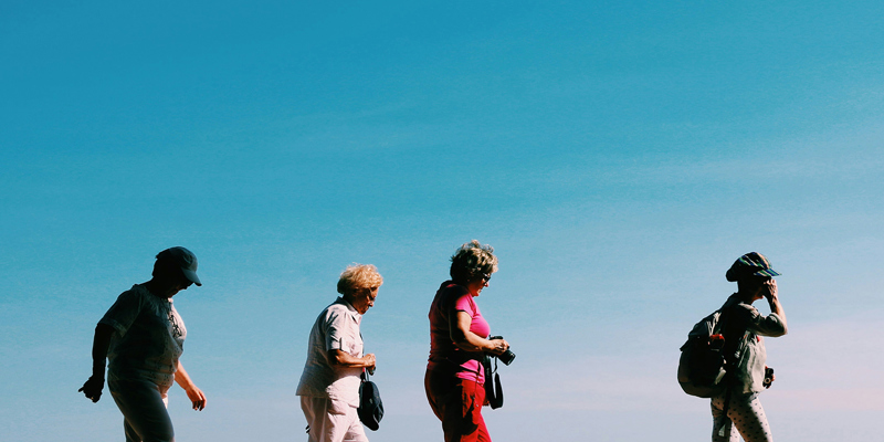 Four middle aged women on a walk with blue skies in the background. The Hughes Report–‘options for redress for those harmed by valproate and pelvic mesh’