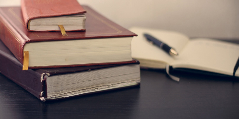 A pile of legal books. The Government has succeeded in its plan to reduce spending on legal aid but at what cost?