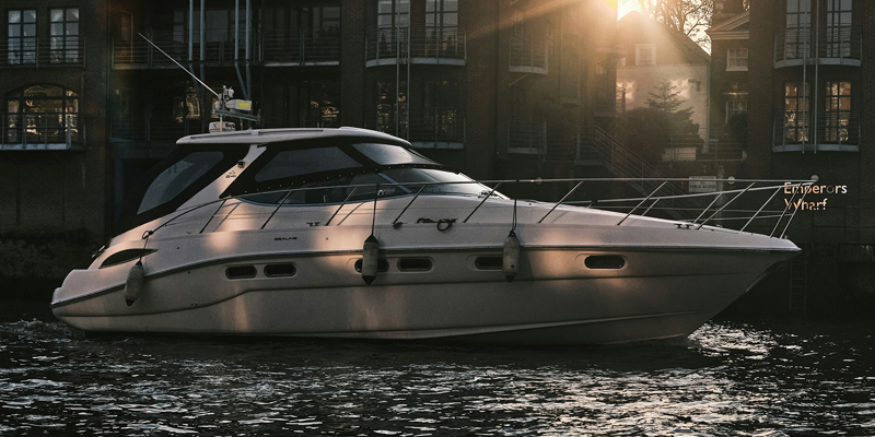 The image shows a small white yacht on water