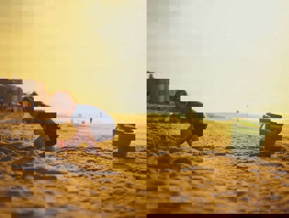 A child on a beach with a bucket and spade. Practical tips for travelling abroad after separation