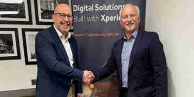 Iain O'Kane and Chris Harthman shake hands on a deal on the sale of GCC Group to Xperience. 
