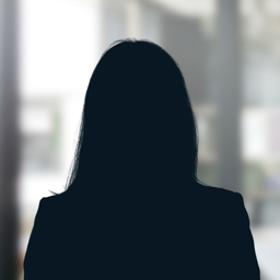Russell-Cooke Solicitors staff photograph. Silhouette of a female team member against the backdrop of an office window with a soft focus effect.