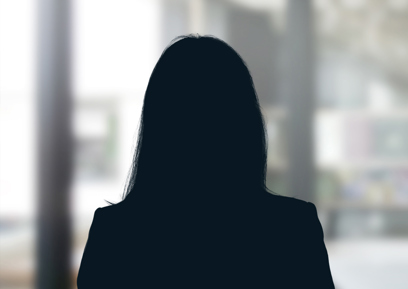 Russell-Cooke Solicitors staff photograph. Silhouette of a female team member against the backdrop of an office window with a soft focus effect.