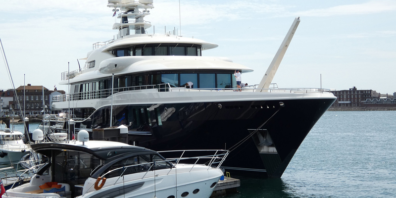 The picture shows a yacht moored at a marina. 