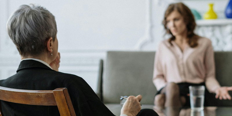 A grey-haired woman in the foreground facing a younger women, who looks frustrated. Understanding MIAMs: the first step in family mediation
