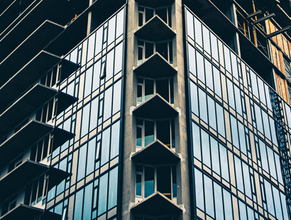 An exterior of a modern high rise residential building under construction. Binding decision on retrospectivity on the Building Safety Act