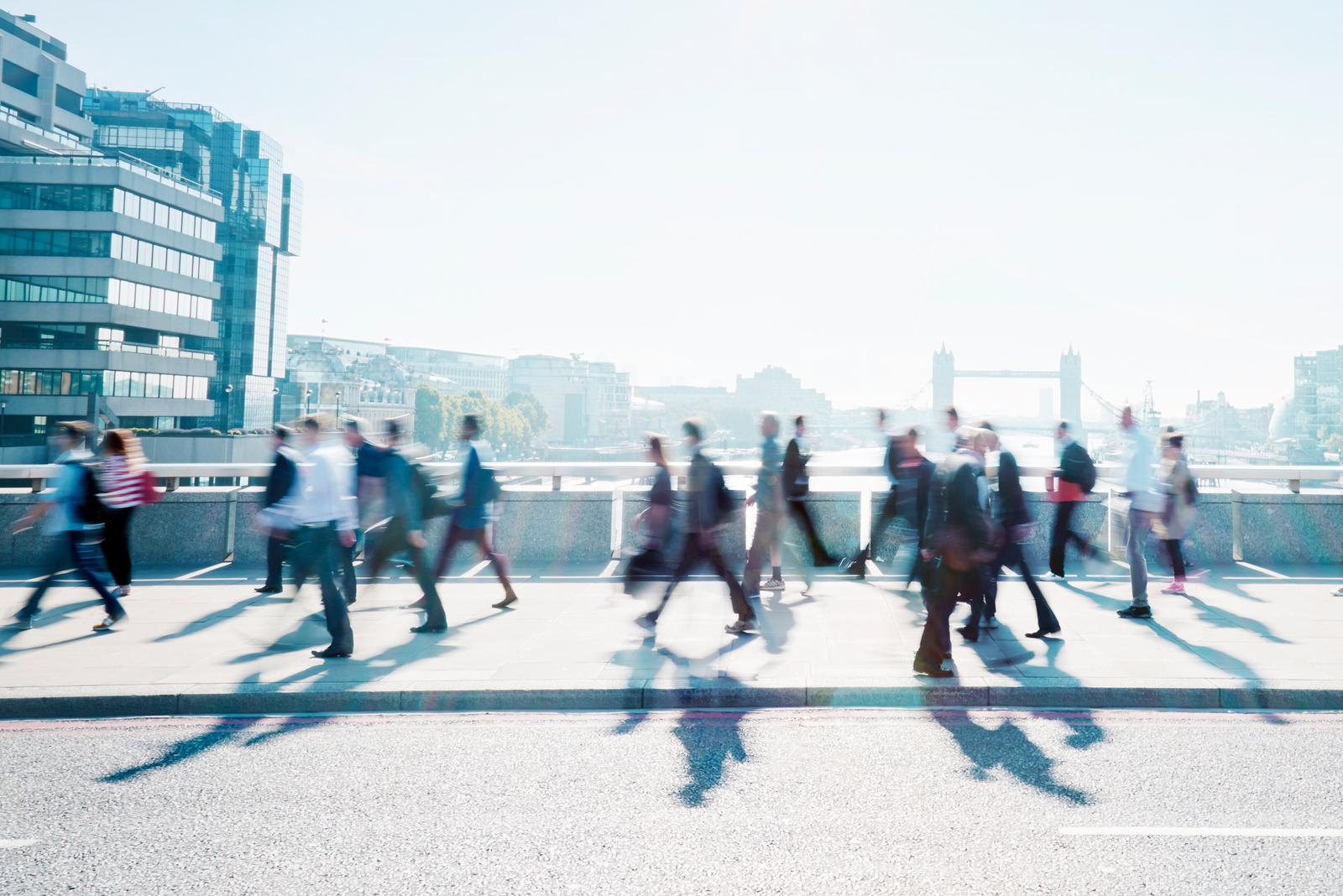 People walking across a bridge in the City. Russell-Cooke Solicitors London
