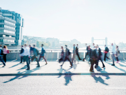 People walking across a bridge in the City. Russell-Cooke Solicitors London