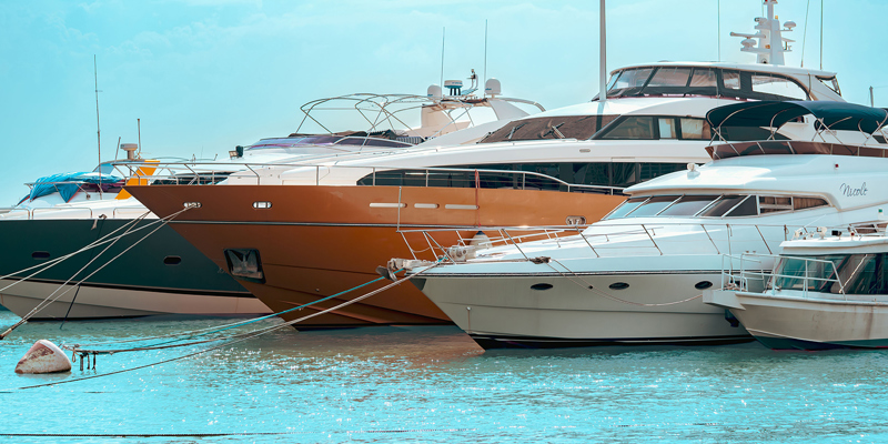 The image shows four boats of varying sizes moored up 