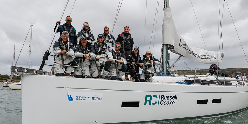 Nine people aboard a white sailing boat. Russell-Cooke's crew at the Silicon Cup Regatta 2025