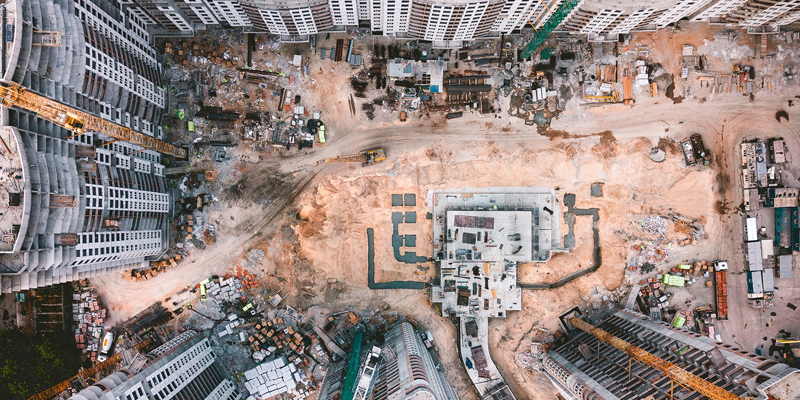 Birdseye view of construction site or land to be built on. Overage and clawback on sales of land —considerations for sellers