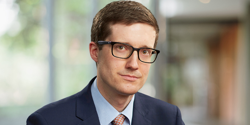 The image shows a man in a suit. 