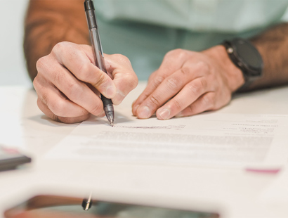 man signing paperwork. Future general election and the impact on IHT -  inheritance tax. 