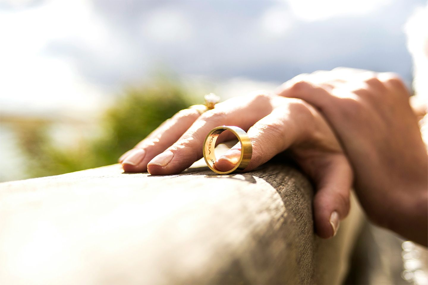 A person holding a wedding band on a bench / fence. Key lessons for family lawyers as relationship landscapes change and rise of ‘no-fault divorces’—Today’s Family Lawyer