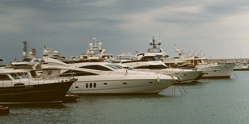 The picture shows several yachts of varying sizes anchored in a marina in the British isles. 