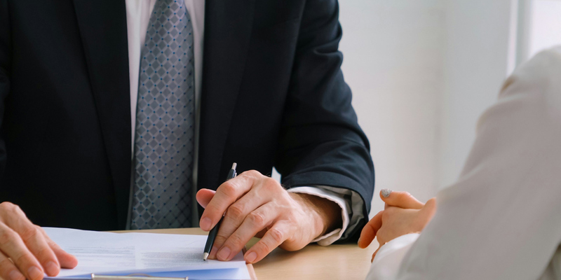Lawyer looking at contract with client