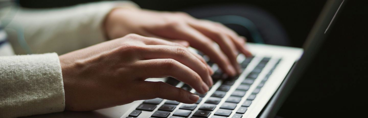 Person typing on keyboard