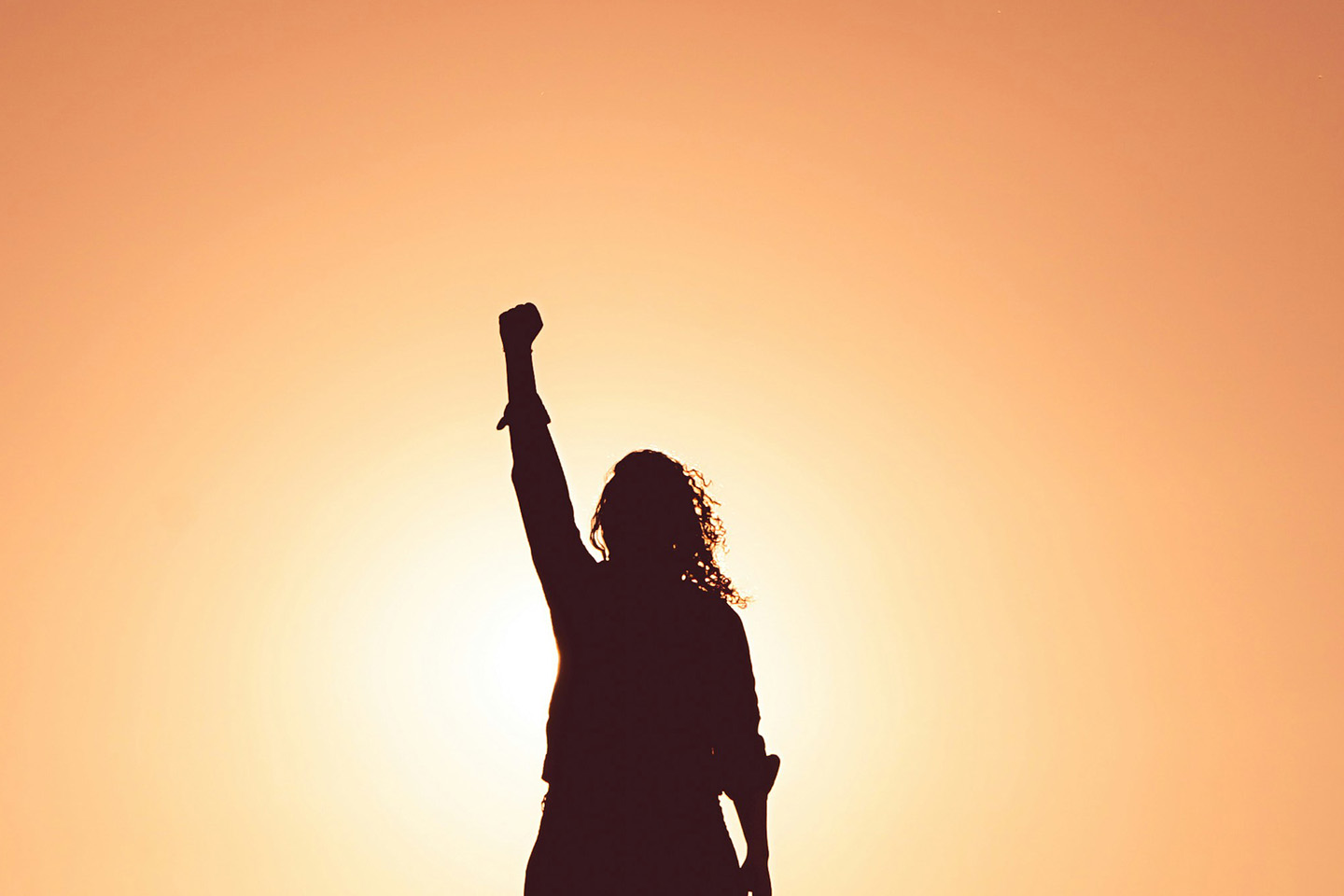 A female silhouette punching her fist in the air in the sun. Equality in practice: what does it look like to work at Russell-Cooke on IWD in 2024?