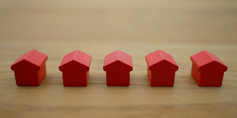 A row of red wooden model houses. EG’s top 10 property law cases of 2023