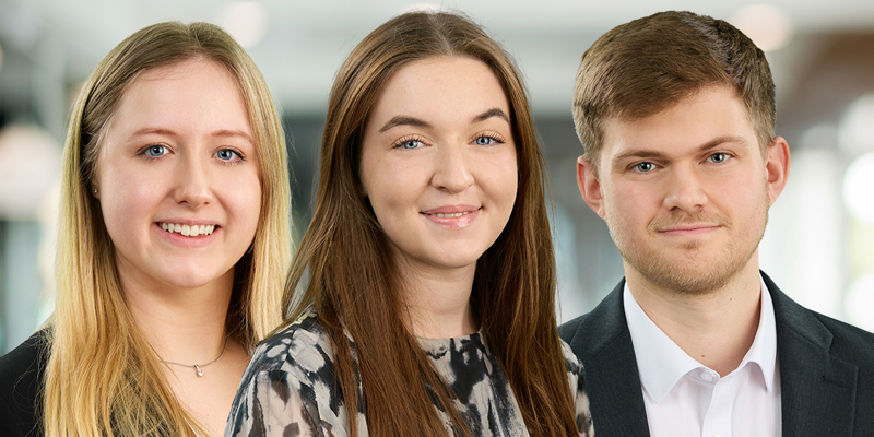 The image shows a blonde haired femal in a black blazer, a brunette female in a printed top and a mousy-haired male in a white shirt and black blazer. Russell-Cooke announces three legal assistants Ella Barker, Molly Lockhart and Oliver Ward completing QWE towards qualification