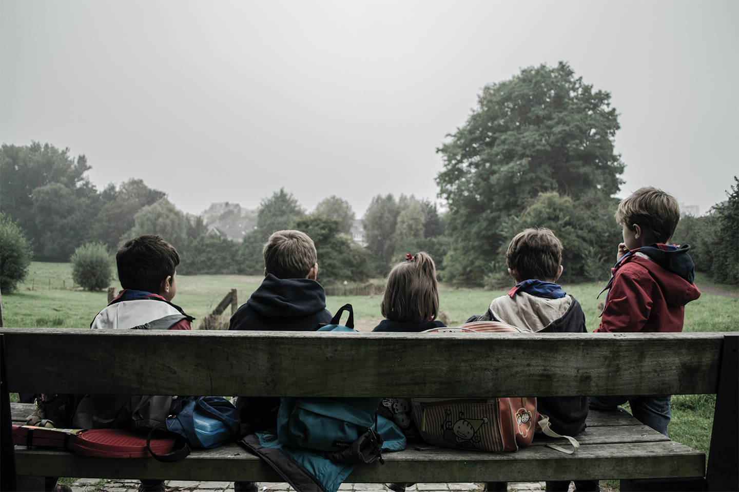 children sitting on a bench in the countryside. family-court-transparency-pilot-russell-cooke-news-2023