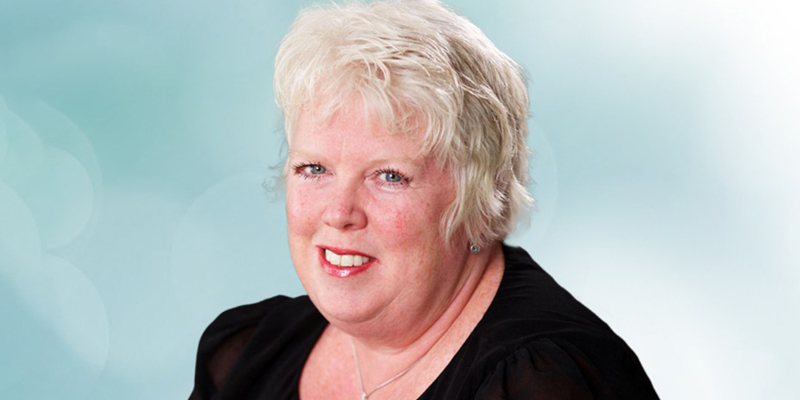 The pictures shows a picture of children's lawyer Sarah Richardson in a black top, silver necklace, short blonde hair. 