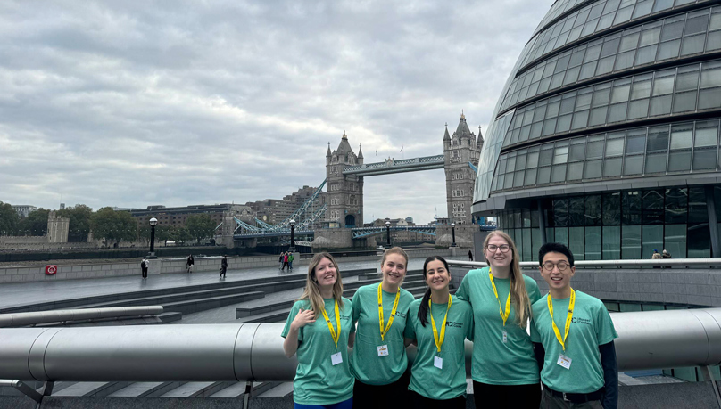 The picture shows five women dressed in Russell-Cooke green t-shirts in front of London Bridge for the London Legal Walk 2025
