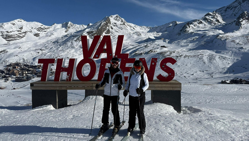 The image shows two skiiers posing for a photo by the Val Thorens sign in the mountains. PropSki 2026 Russell-Cooke headline sponsor
