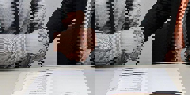 Hands shaking over a deal