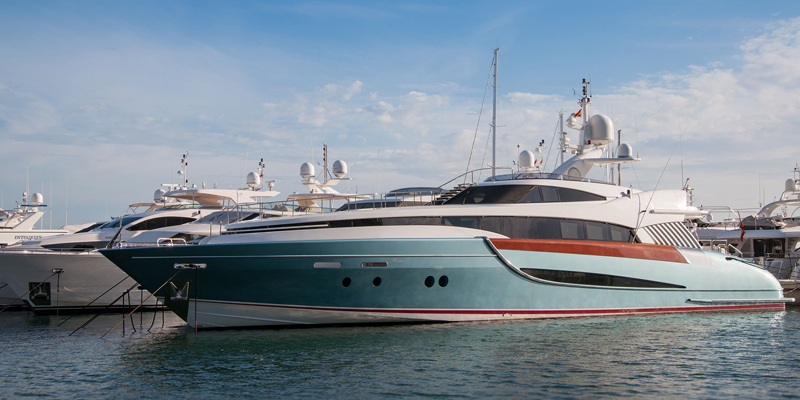 The picture shows a yacht moored at a marina. 