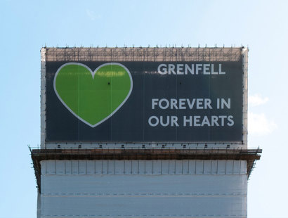 Grenfell Tower Inquiry Phase 2 Report findings – Legal support from Russell-Cooke for Grenfell victims. Image of a banner covering the Grenfell Tower. The banner has a large green heart and the words "Grenfell, forever in our hearts".