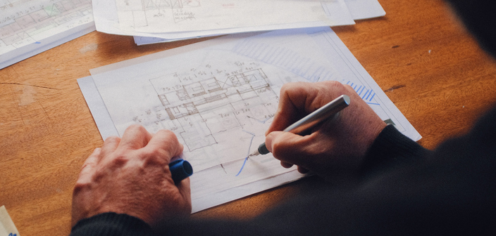 A man's hands drawings architectural floorplan drawings. Who owns the copyright after you pay an architect for drawings or plans? —The Times