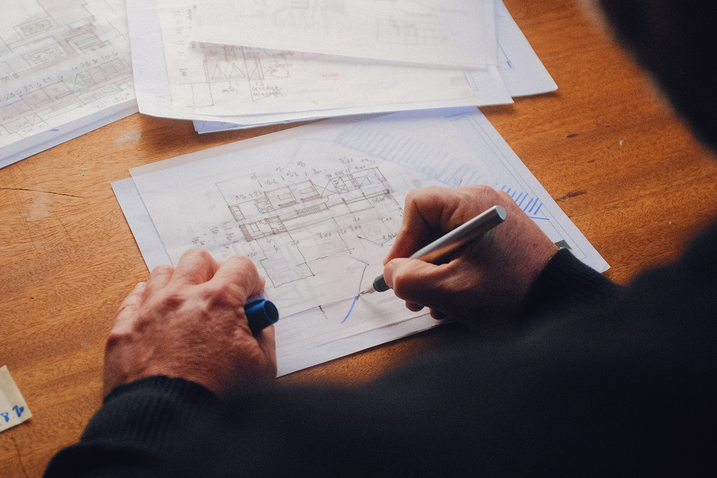 A man's hands drawings architectural floorplan drawings. Who owns the copyright after you pay an architect for drawings or plans? —The Times