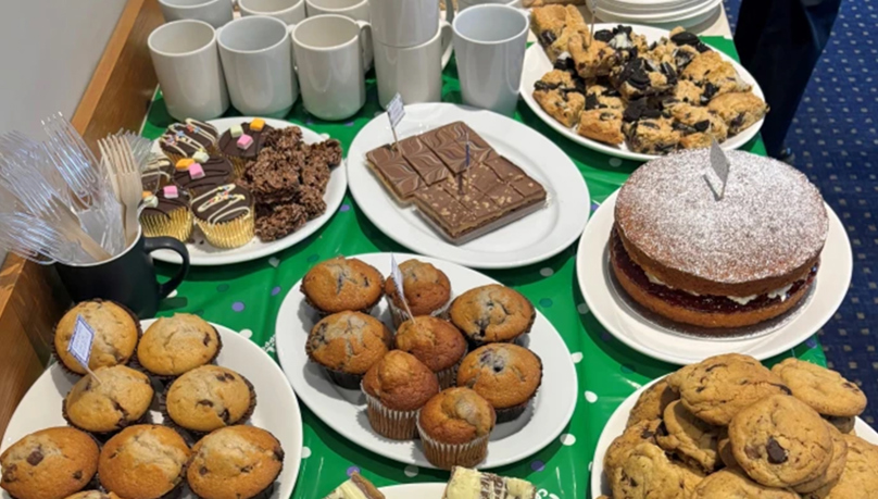 The picture shows an array of sweet treats, cakes and biscuits for a macmillan coffee morning. 