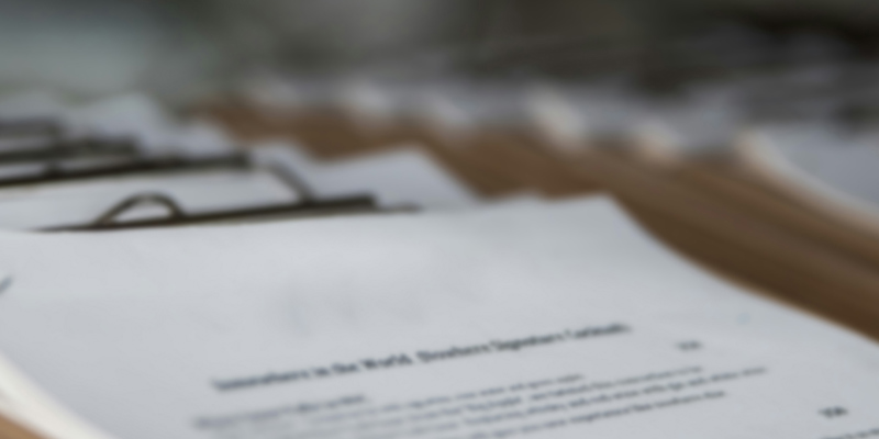 A blurred picture of documents piled up. “The deceased is very much alive”—examining the recent case of Ashimola v Samuel