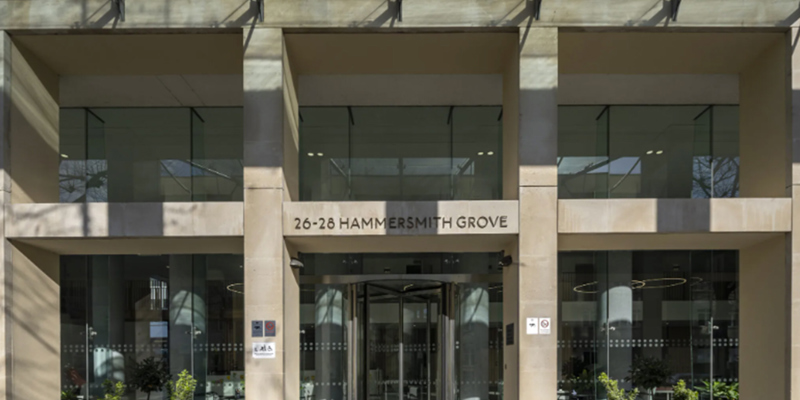 The image shows the exterior of a building with chrome signage saying 26-28 Hammersmith Grove' 